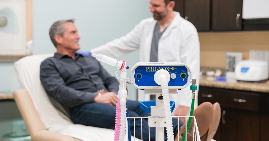 Patient and doctor in background with pro nox anesthesia machine in front