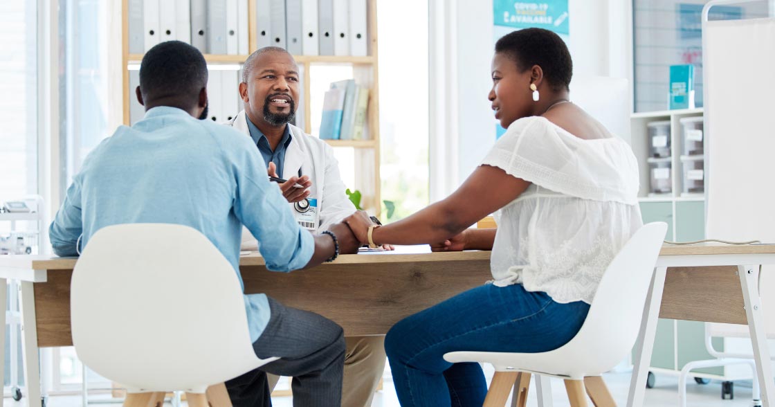 Physician speaking with a couple about fertility planning